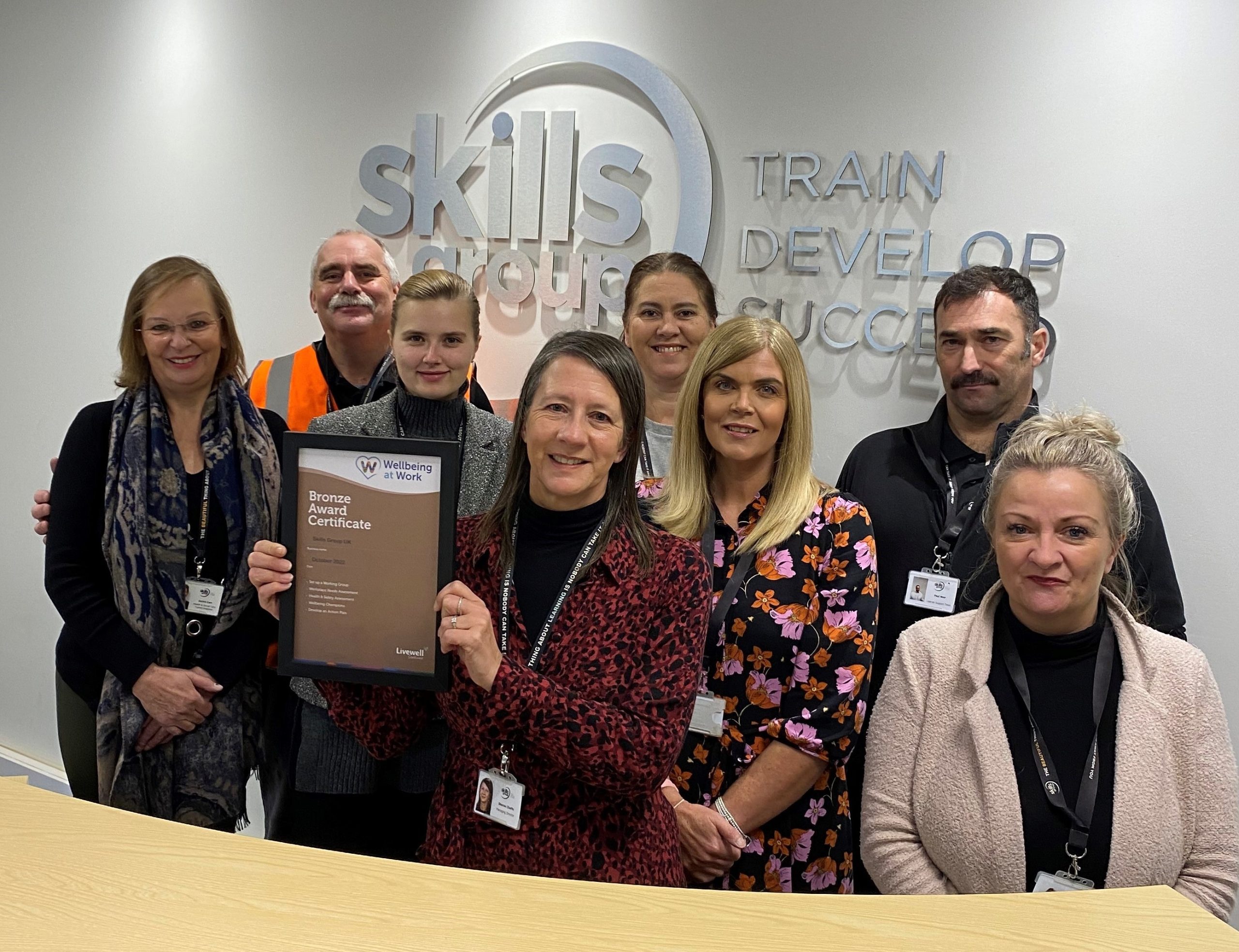 Skills Group team smile for a photo with their Bronze Certificate